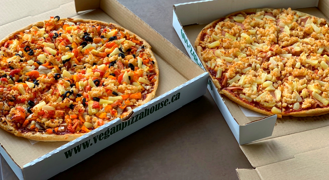 Two Vegan Pizza House pizzas in boxes